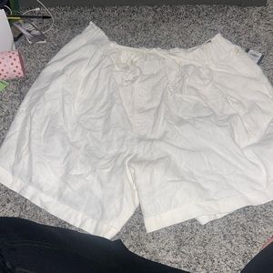 white shorts with a wrap around tie that can make a bow in belt straps